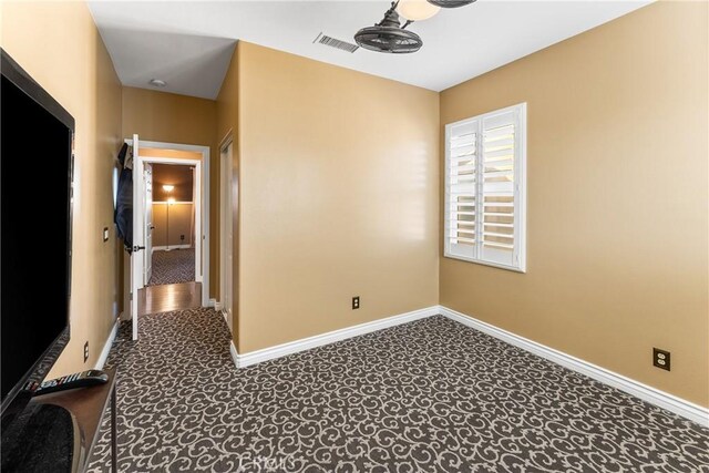 unfurnished room with visible vents and baseboards