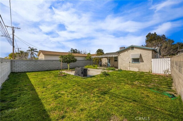 view of yard with a patio area and a fenced backyard