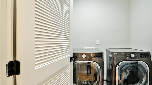 washroom featuring washer and dryer and laundry area