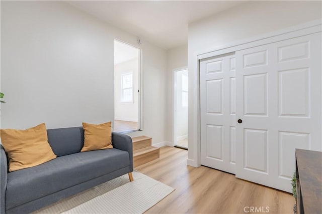 living room with light wood finished floors and baseboards