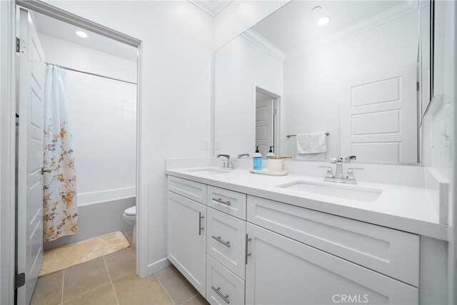 bathroom featuring double vanity, ornamental molding, a sink, and tile patterned floors