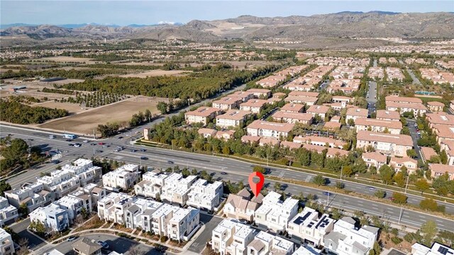 drone / aerial view featuring a residential view and a mountain view