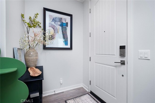 entryway with wood finished floors and baseboards