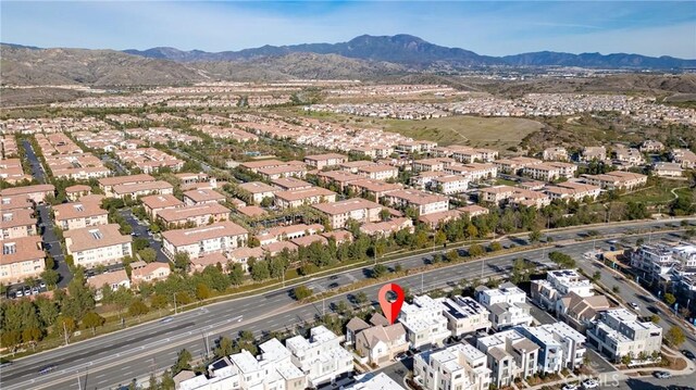 drone / aerial view featuring a residential view and a mountain view