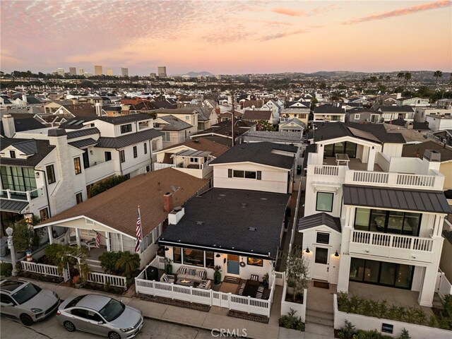 aerial view at dusk with a residential view and a view of city