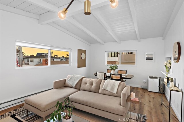 living area featuring baseboards, vaulted ceiling with beams, light wood-style flooring, and baseboard heating