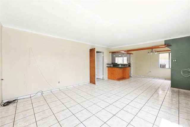 unfurnished living room featuring light tile patterned floors