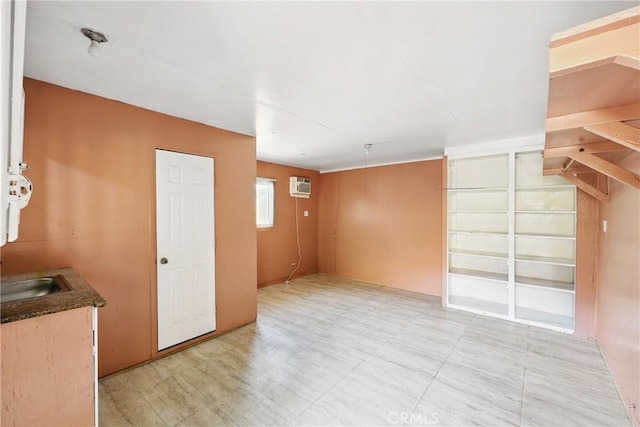 spare room featuring a wall mounted AC and a sink