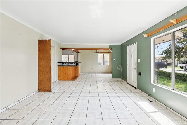 unfurnished living room featuring light tile patterned floors