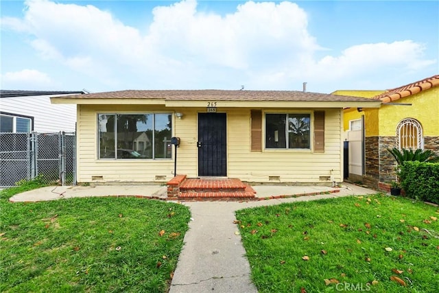 view of front of property with crawl space, a gate, a front yard, and fence