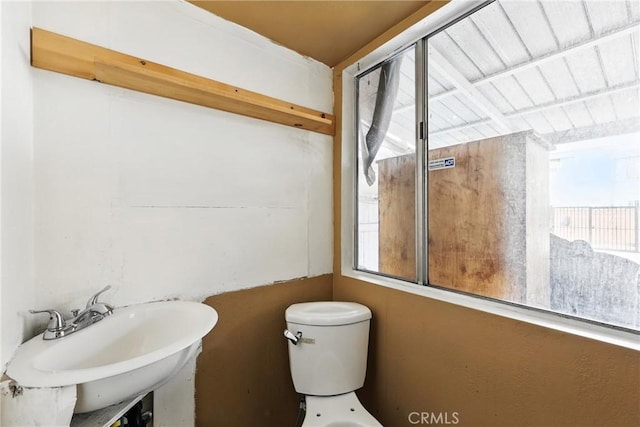 half bath with a sink and toilet