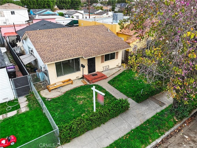 view of front facade with fence, a residential view, a front yard, a gate, and a shingled roof