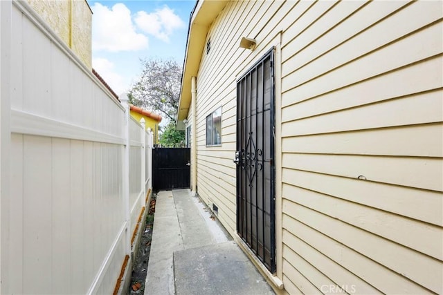 view of side of home featuring fence
