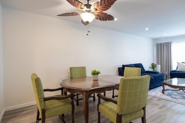 dining space with light wood-type flooring, ceiling fan, baseboards, and recessed lighting