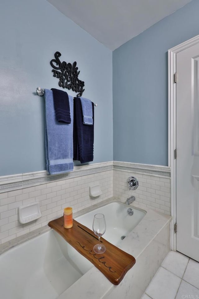 full bath featuring a garden tub and tile patterned flooring