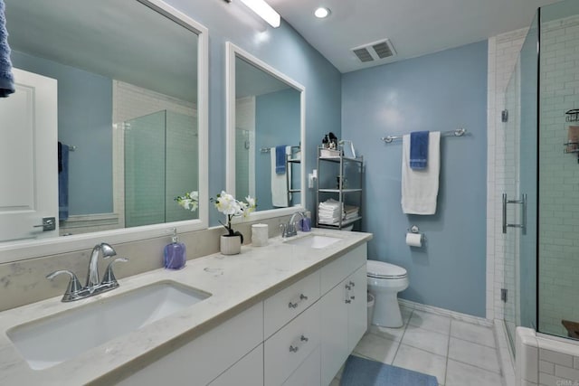 bathroom with tile patterned flooring, toilet, a stall shower, double vanity, and baseboards