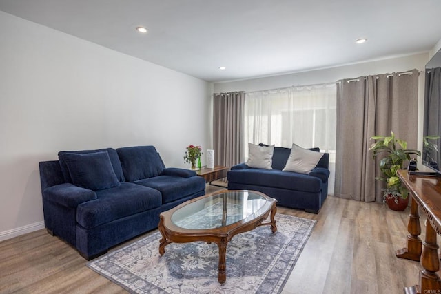 living area with wood finished floors, recessed lighting, and baseboards