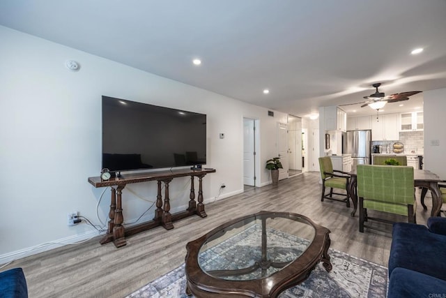 living area featuring wood finished floors, recessed lighting, ceiling fan, and baseboards