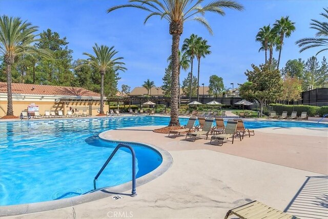 pool featuring a patio area and fence