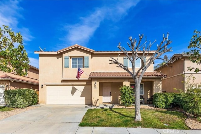 view of front of home featuring driveway, a tile roof, and stucco siding