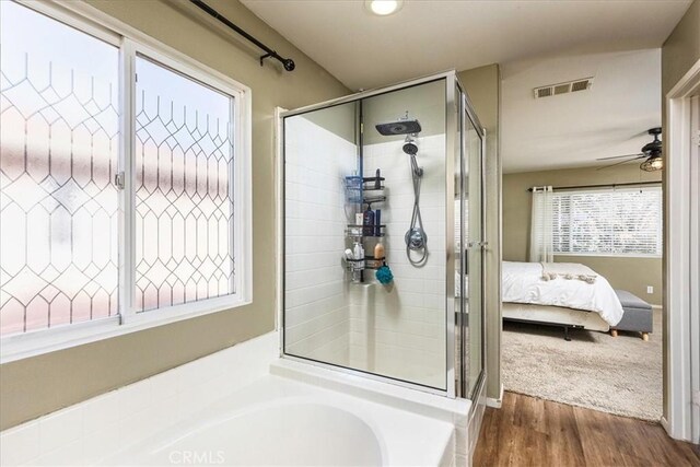 bathroom featuring ensuite bathroom, ceiling fan, a garden tub, visible vents, and a stall shower