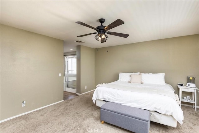 bedroom with baseboards, visible vents, a ceiling fan, ensuite bathroom, and carpet