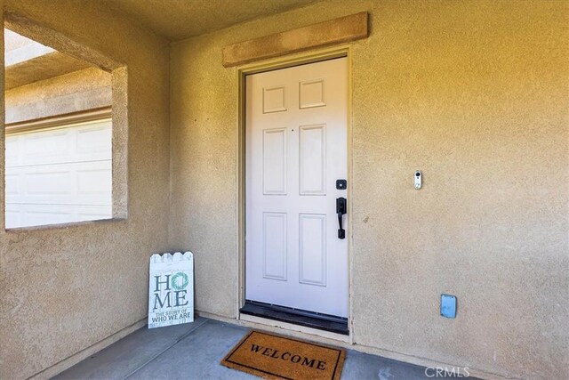 view of exterior entry with stucco siding