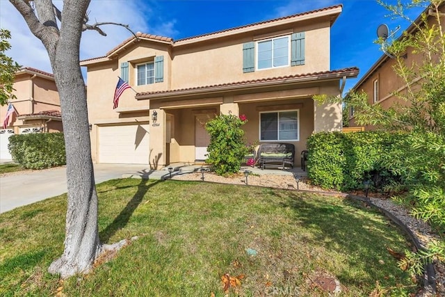 mediterranean / spanish home featuring a tile roof, stucco siding, a front yard, a garage, and driveway