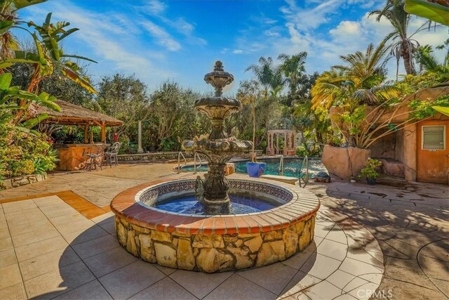 view of patio with outdoor dry bar and a gazebo