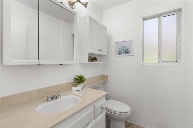 bathroom featuring toilet and vanity