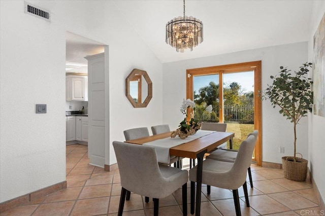 dining room featuring lofted ceiling, light tile patterned floors, a chandelier, visible vents, and baseboards