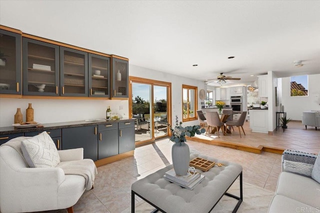 living room featuring light tile patterned floors, ceiling fan, and recessed lighting