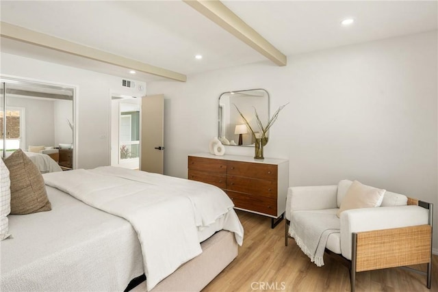 bedroom with recessed lighting, visible vents, beamed ceiling, and wood finished floors