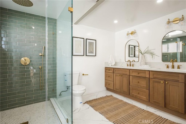 full bath featuring double vanity, toilet, a sink, and tiled shower