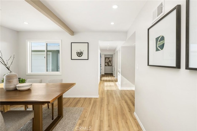 hall with light wood finished floors, baseboards, visible vents, beam ceiling, and recessed lighting