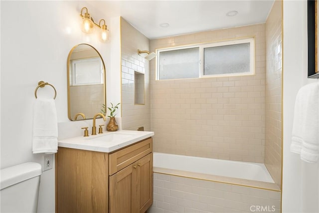 full bath featuring tiled shower / bath combo, toilet, and vanity