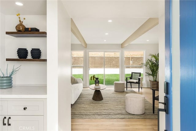 living area with light wood-style flooring, beamed ceiling, and recessed lighting