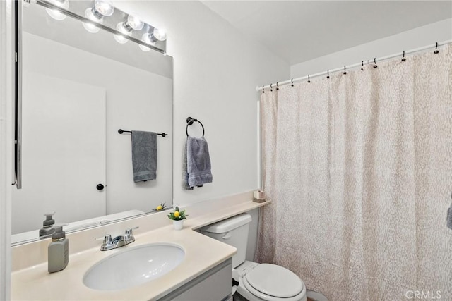 bathroom featuring toilet and vanity