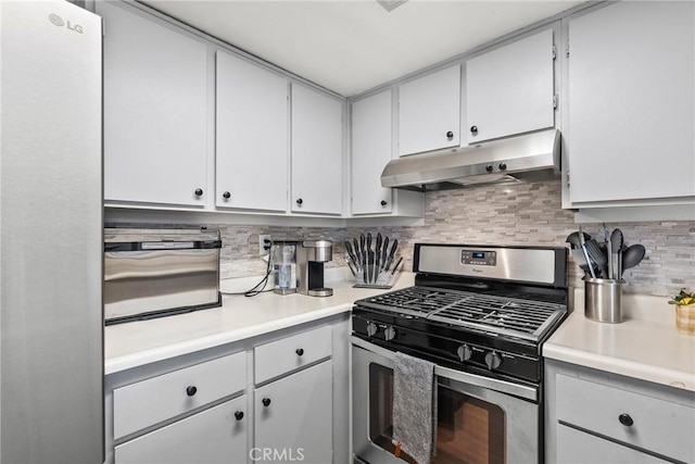 kitchen with stainless steel gas range, light countertops, under cabinet range hood, and decorative backsplash