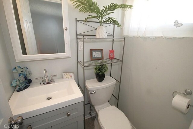 bathroom with toilet and vanity