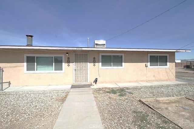 view of front of home featuring central air condition unit and stucco siding