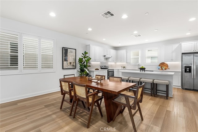 dining area with recessed lighting, visible vents, and light wood-style floors