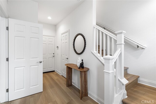 interior space featuring stairs, recessed lighting, baseboards, and wood finished floors