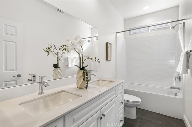 full bath featuring tile patterned flooring, a sink, toilet, and double vanity