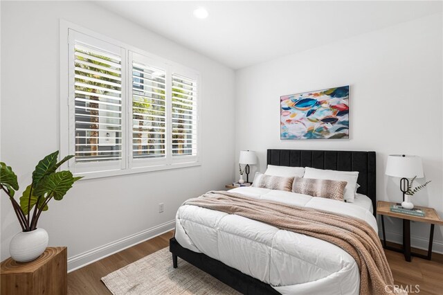 bedroom featuring baseboards, dark wood-type flooring, and recessed lighting