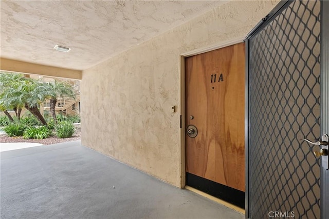 3695 Linden Ave Unit 11A, Long Beach, CA 90807 - property entrance with a patio area, visible vents, and stucco siding