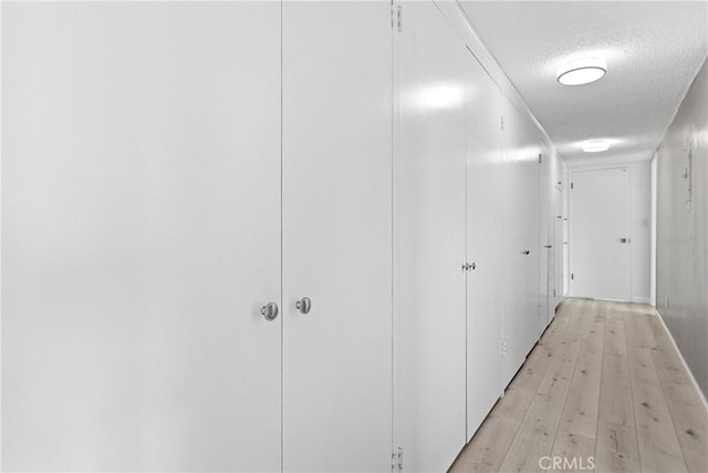 3695 Linden Ave Unit 11A, Long Beach, CA 90807 - corridor featuring a textured ceiling and light wood-style floors