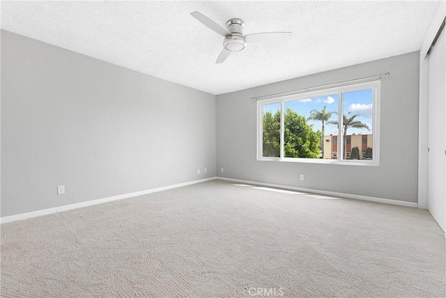 3695 Linden Ave Unit 11A, Long Beach, CA 90807 - carpeted empty room featuring a ceiling fan, baseboards, and a textured ceiling