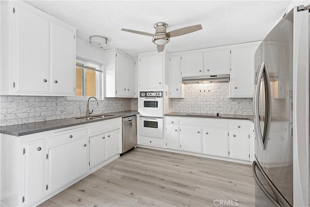 3695 Linden Ave Unit 11A, Long Beach, CA 90807 - kitchen with under cabinet range hood, stainless steel appliances, dark countertops, a ceiling fan, and a sink