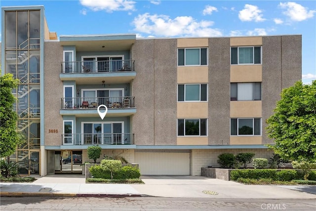 3695 Linden Ave Unit 11A, Long Beach, CA 90807 - view of building exterior with a garage and concrete driveway